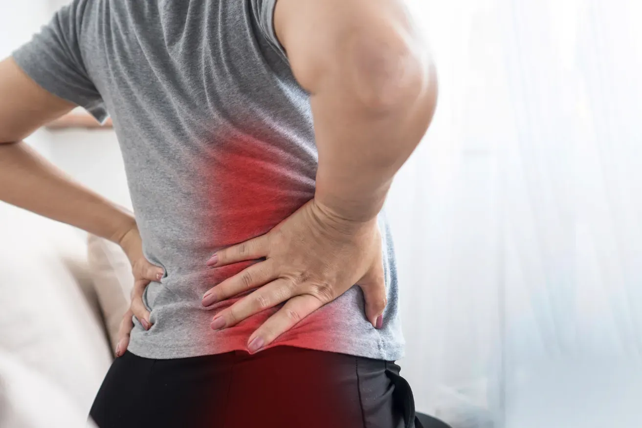 Woman experiencing back pain from large breasts