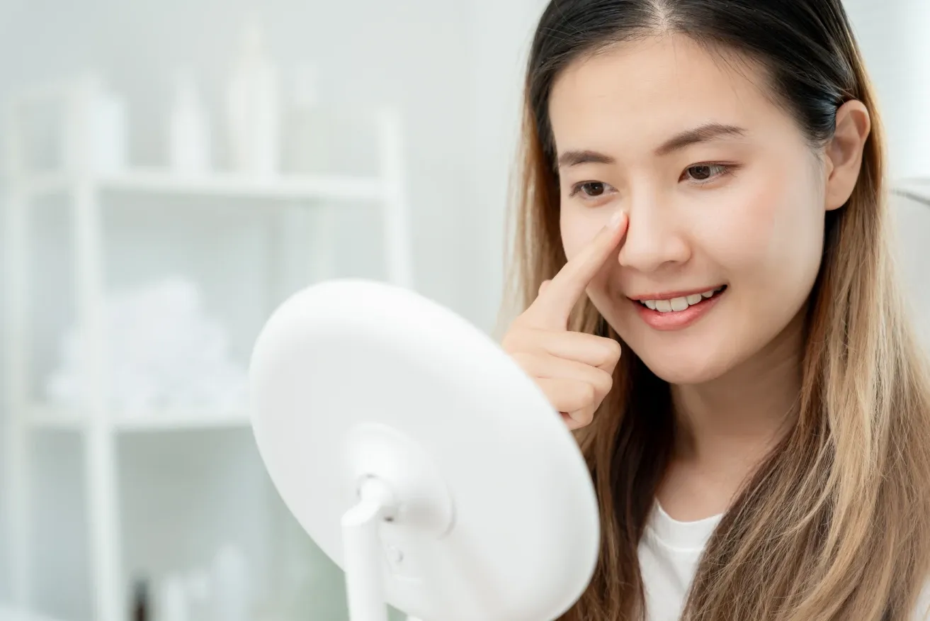 Patient viewing her reflection during an epicanthoplasty consultation