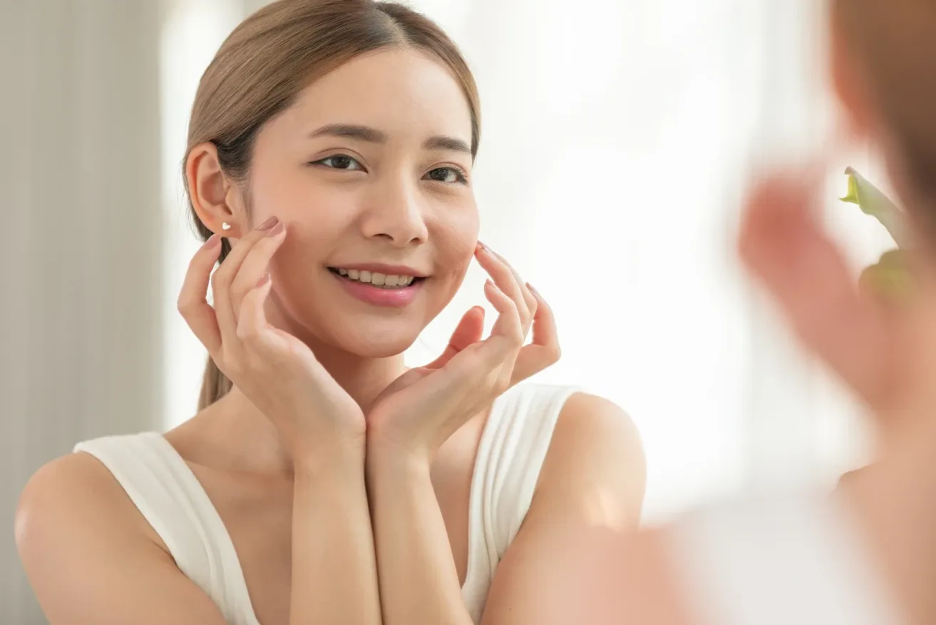 Woman smiling while looking at her reflection