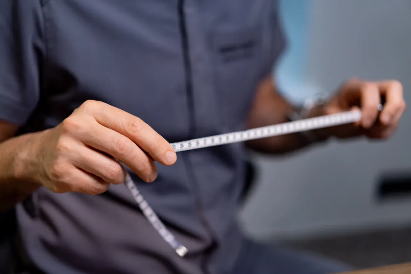 Plastic surgeon performing measurements