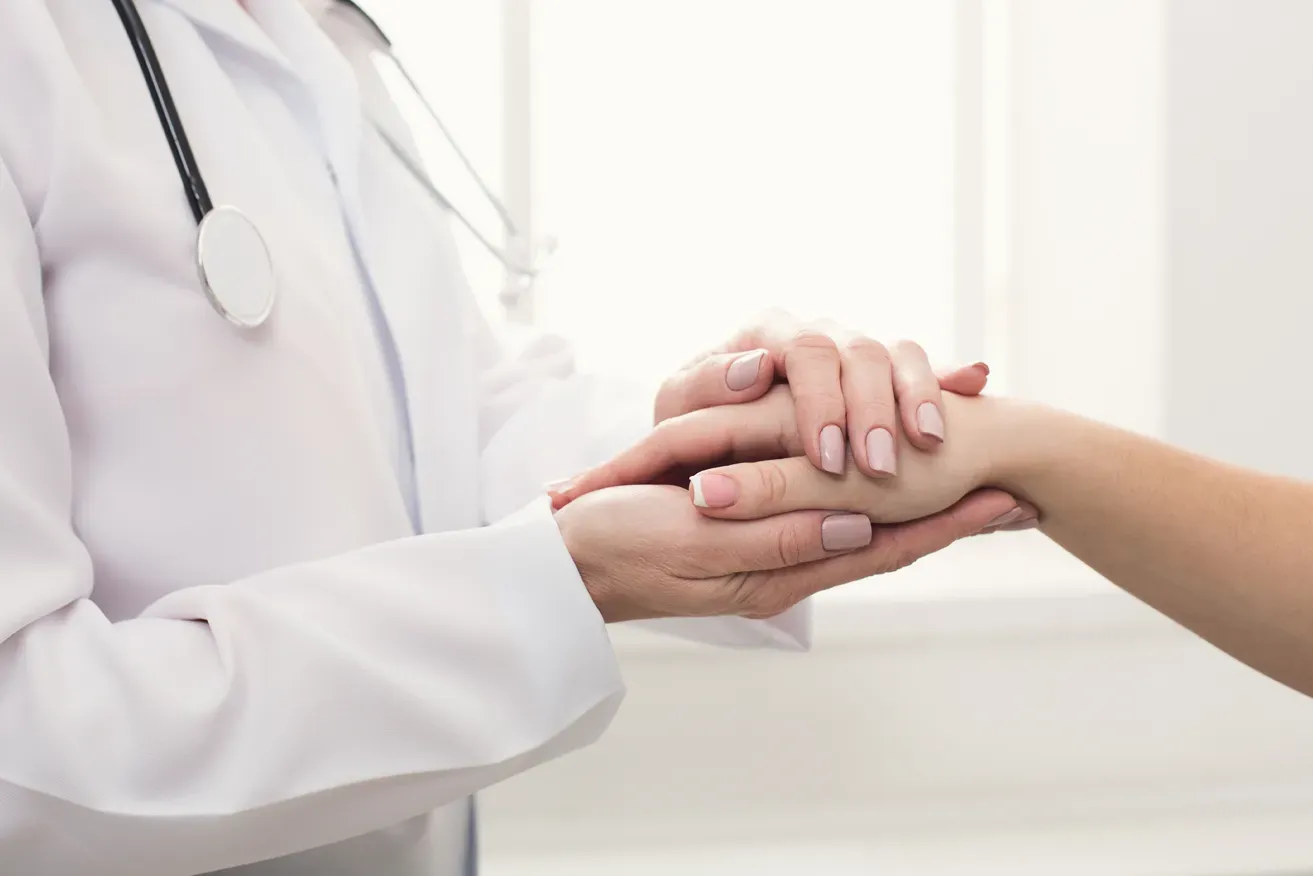 Plastic surgeon reassuring patient