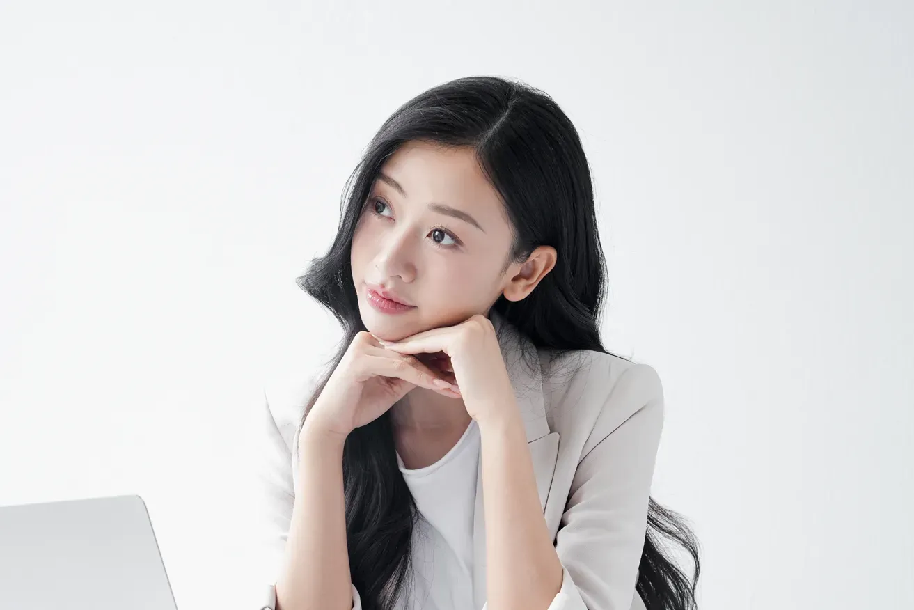 Woman thinking of questions before plastic surgery consultation