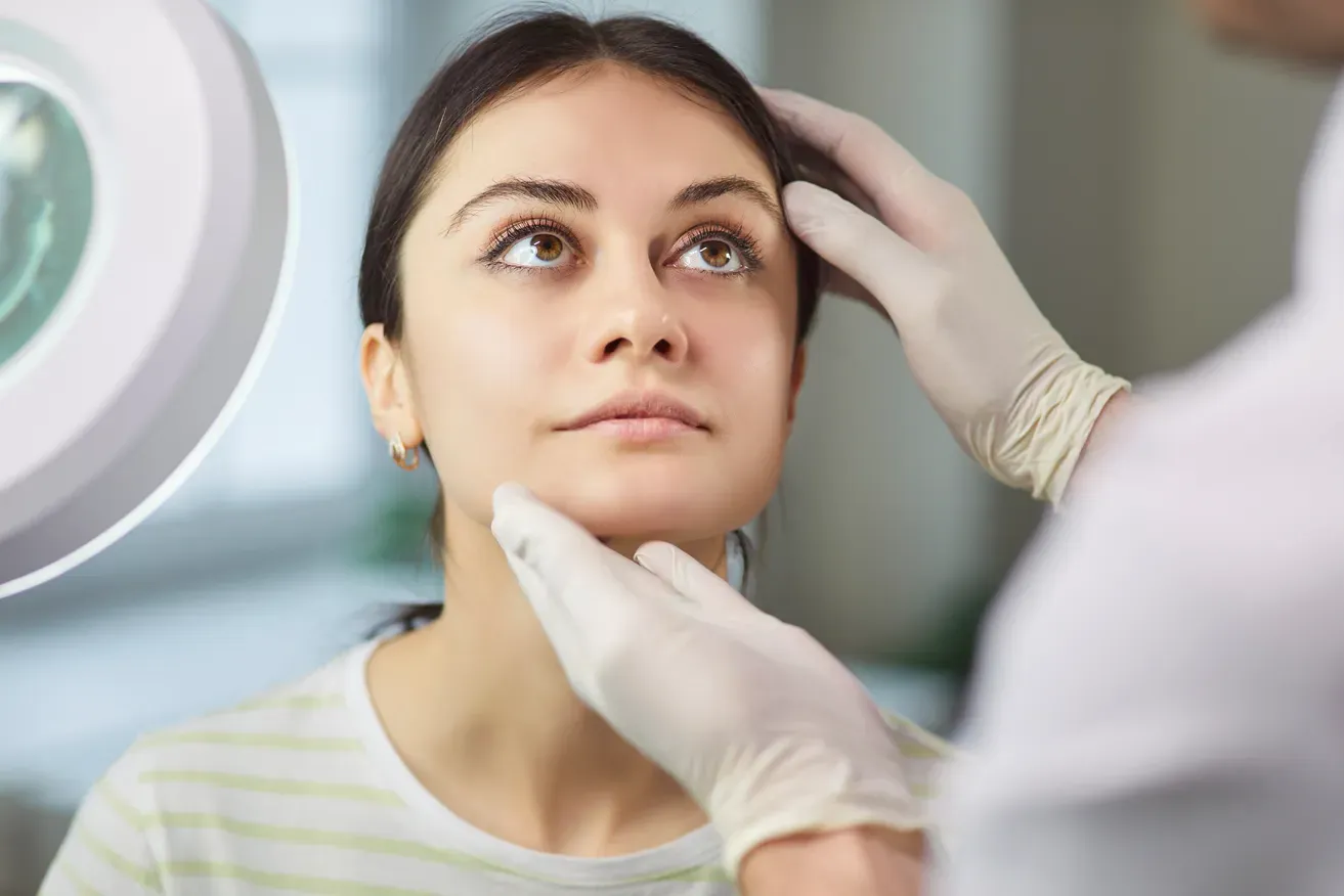 Doctor assessing a lady's face