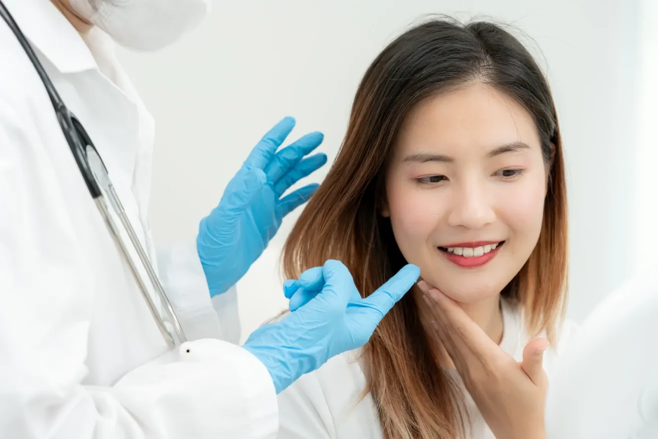Plastic surgeon assessing patient’s face