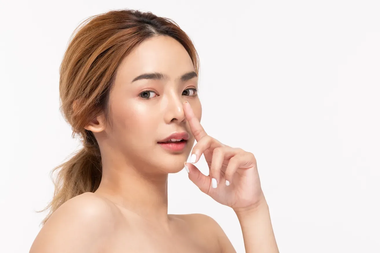Woman pointing to her nose